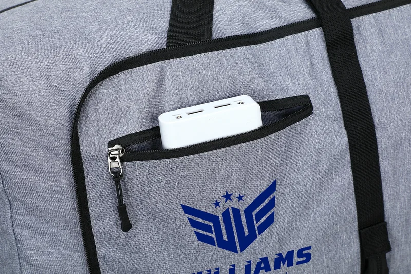 Angled view of the branded Overnighter Foldable Travel Duffel's carry handles