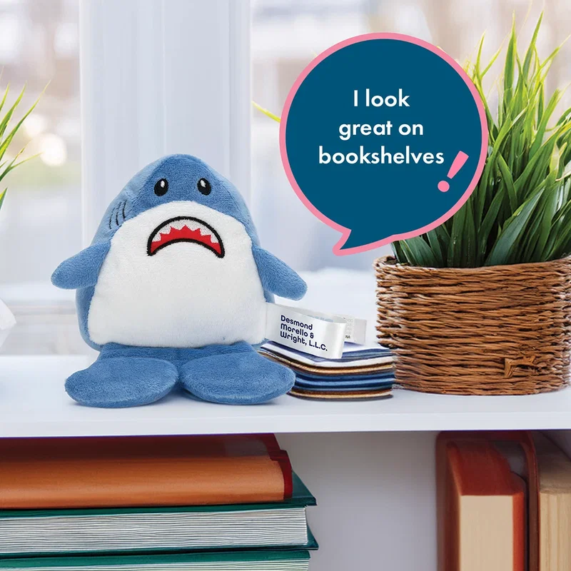 Angled view of the Phone Pals Weighted Plush Phone Holder resting on a desk, style 3 of 3