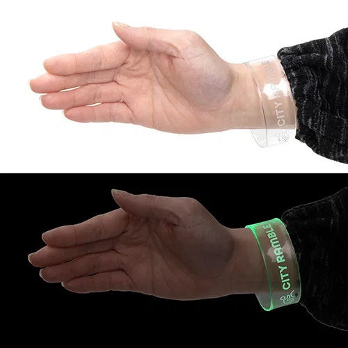 Custom branded Pixie light-up wristband glowing, front view of promotional LED wristband