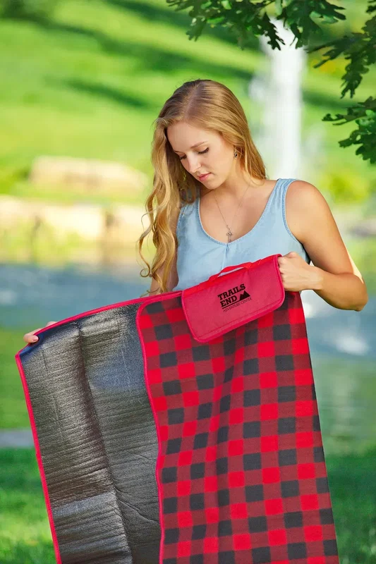 Promotional roll-up fleece blanket shown carried by the strap