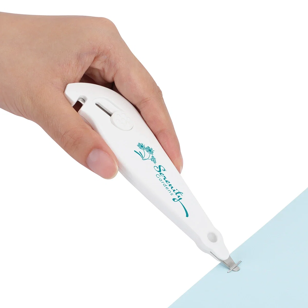 Branded Porter 3-in-1 tool's staple remover removing a staple from a folded paper edge, in-use demonstration