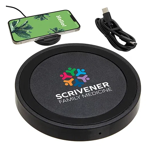 Branded Power Disc charging pad on a desk, promotional wireless charger lifestyle shot