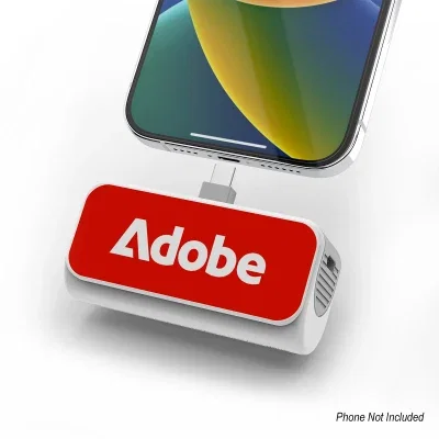 Compact power bank shown beside a smartphone for scale