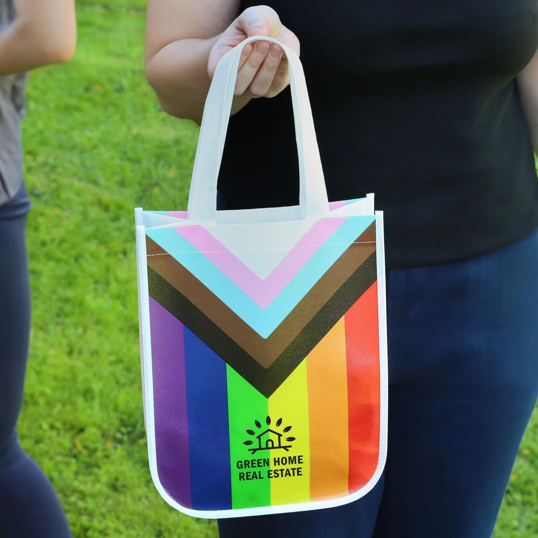 Progress Pride Laminated Fashion Tote Bag held in hand