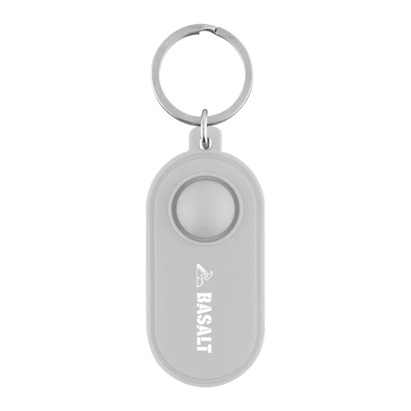 Purple tag laid flat beside a keyring