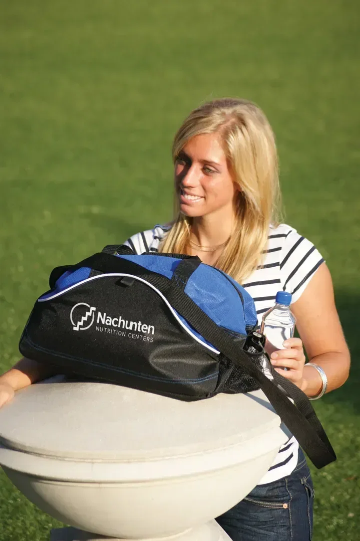 Quick Kick Non-Woven Duffel Bag held in hand