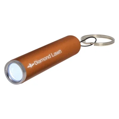 Mini flashlight lit up in a darkened room