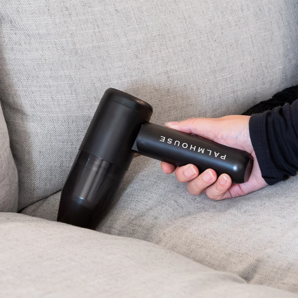 Hand holding the rechargeable unit by its grip