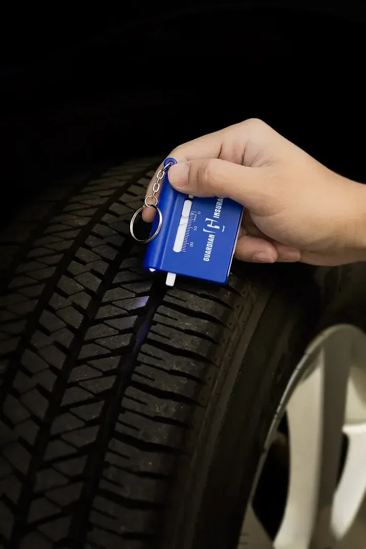 Promotional branded Roadside multi-tool with flashlight lit, side view