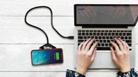 SCX Innovative Design™ Bamboo 10W Hexa Wireless Charger in use