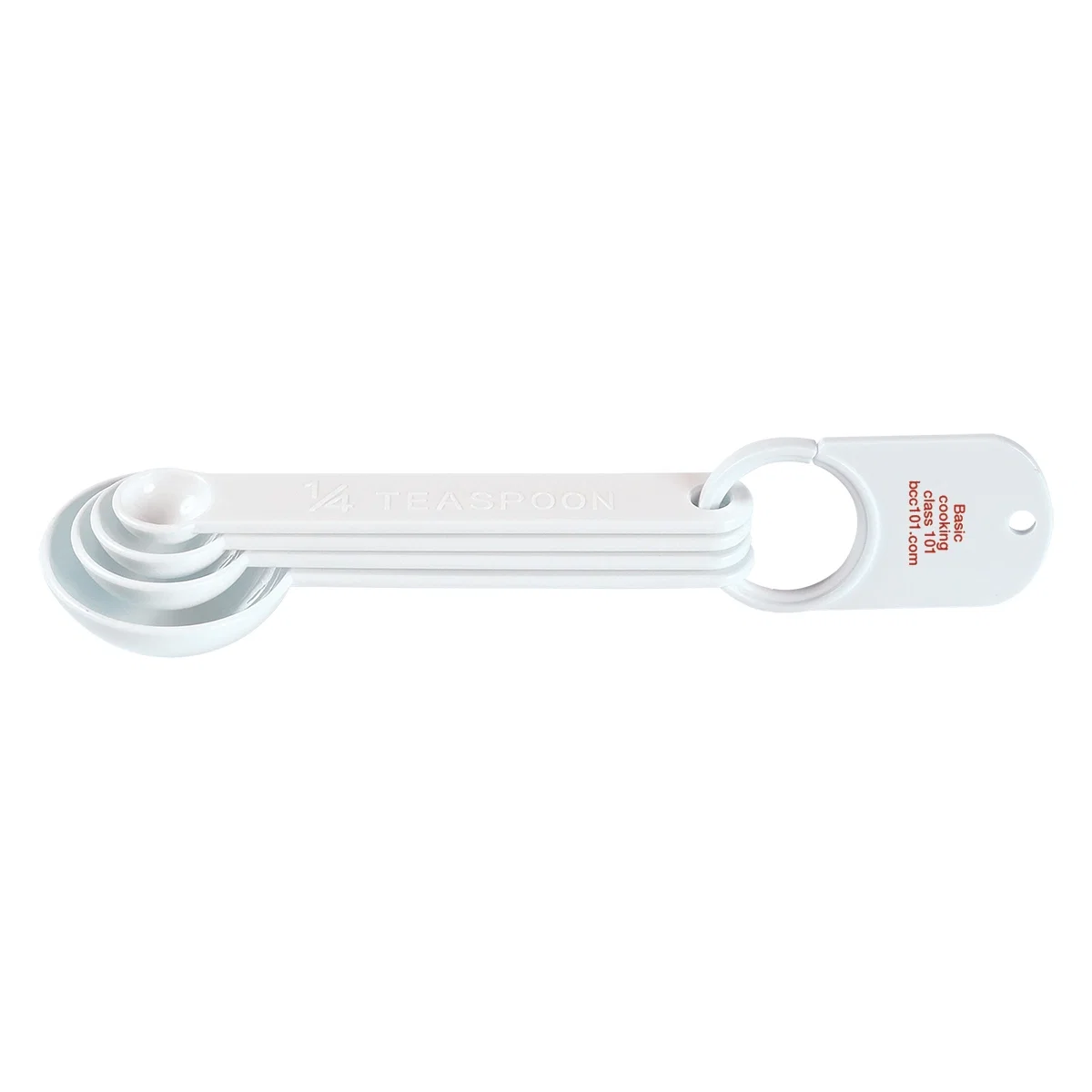 Four white measuring spoons joined on a single ring