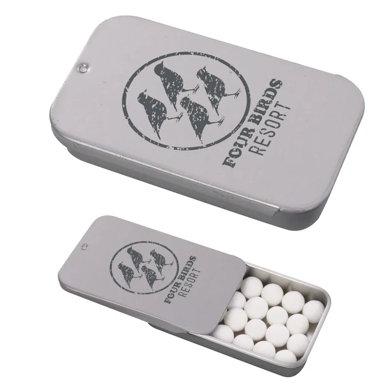 Mints spill out beside the opened metal case