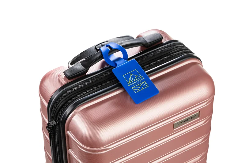 Silicone Luggage Tag attached to a suitcase handle, lifestyle in-use shot