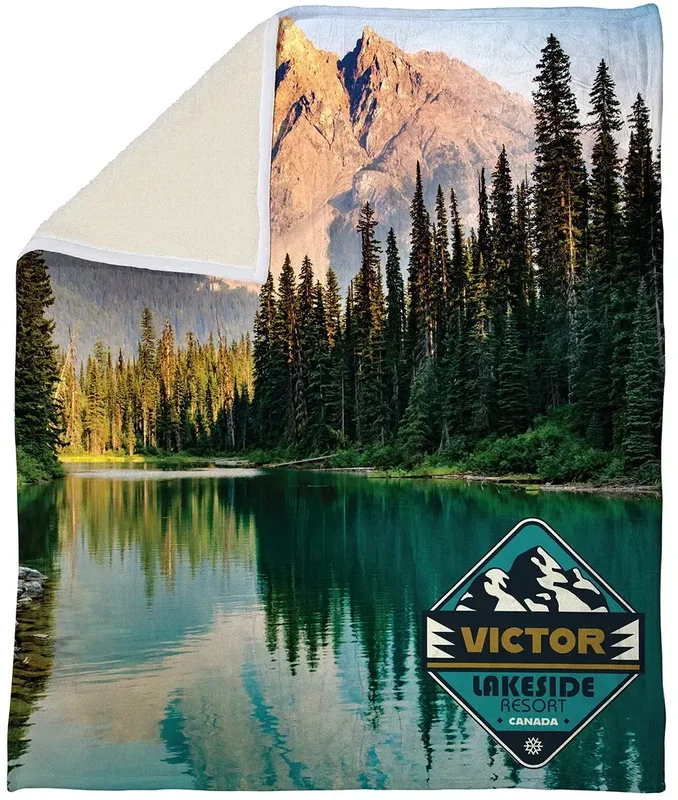 Corner detail of the branded Silk Touch sherpa blanket showing the plush sherpa back and logo