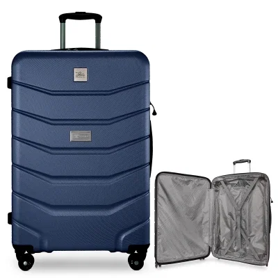 Hardside check-in spinner standing upright with wheels on the floor