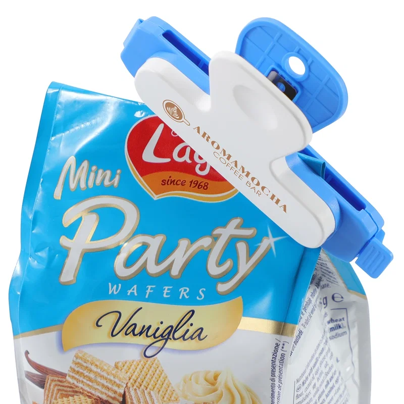 Snap-Lock Bag Clip held between two fingers to illustrate its compact size