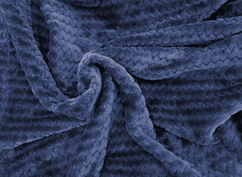 Angled view of the Snuggle Up blanket folded and displayed