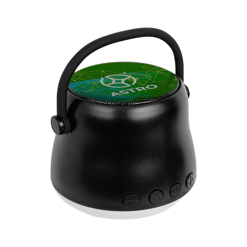 Speaker placed on a nightstand beside a phone
