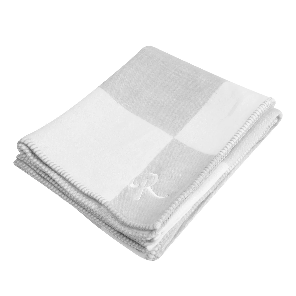 Two tone throw blanket folded neatly on a flat surface