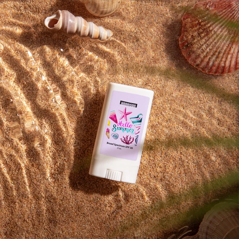 Held in one hand beside a beach towel