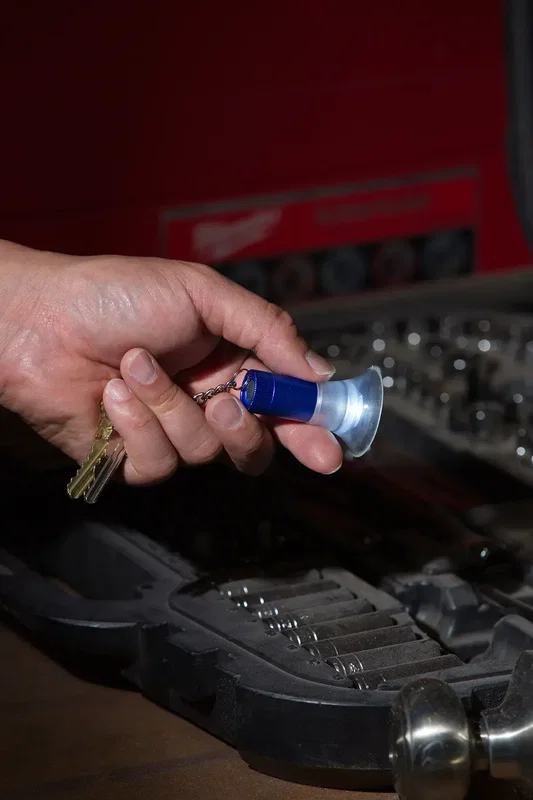 Custom branded keylight gripping a surface with its silicone suction legs
