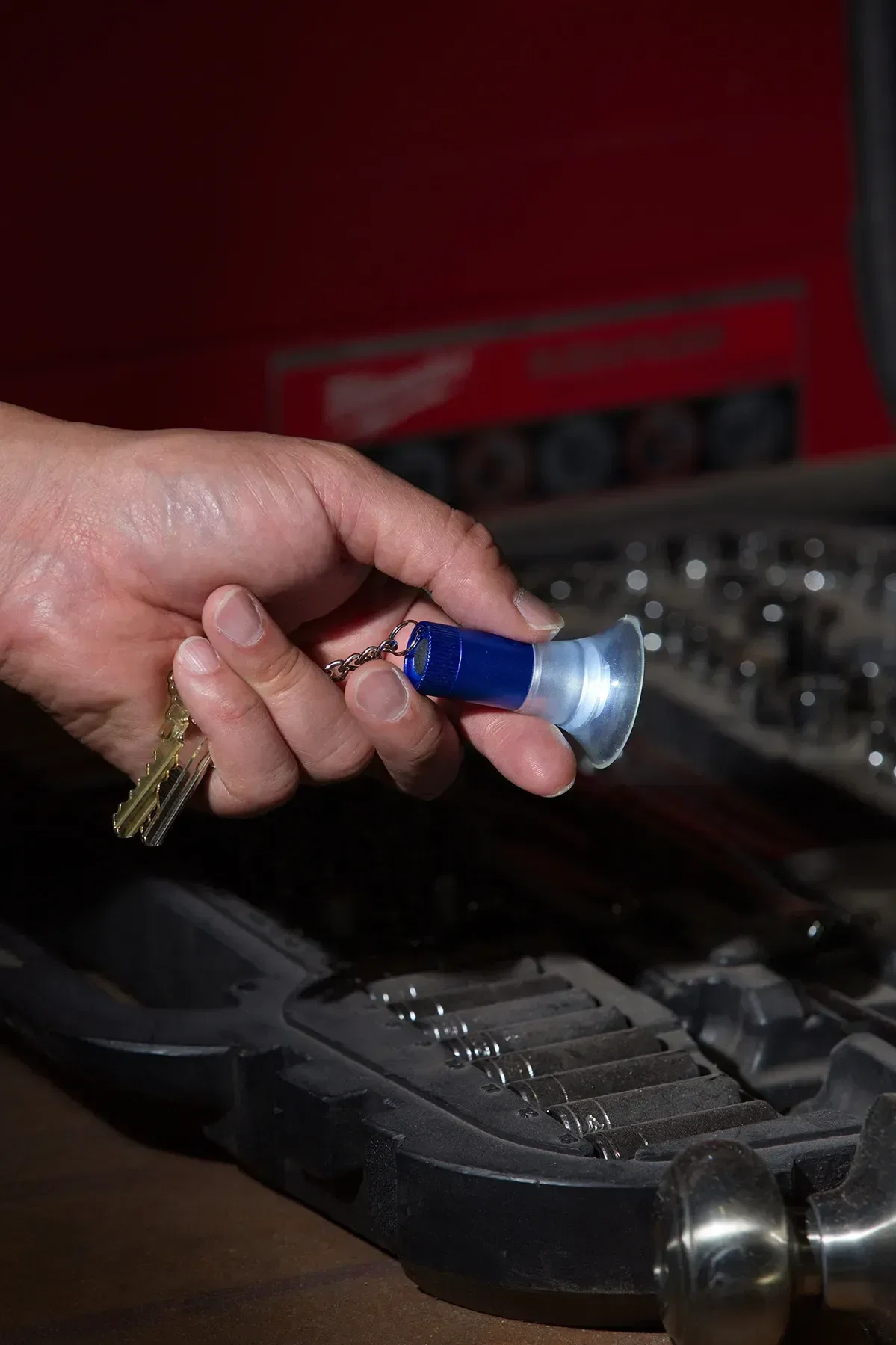 Custom branded keylight gripping a surface with its silicone suction legs