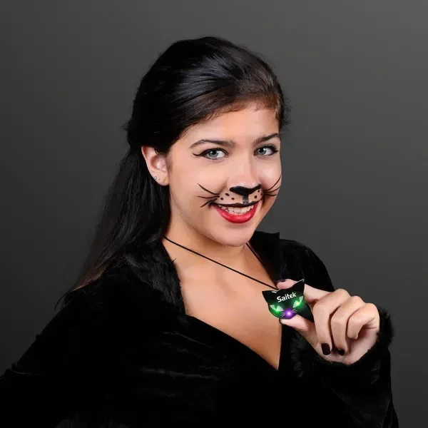 Spooky Cat Eyes Necklace, LED Halloween Jewelry held in hand