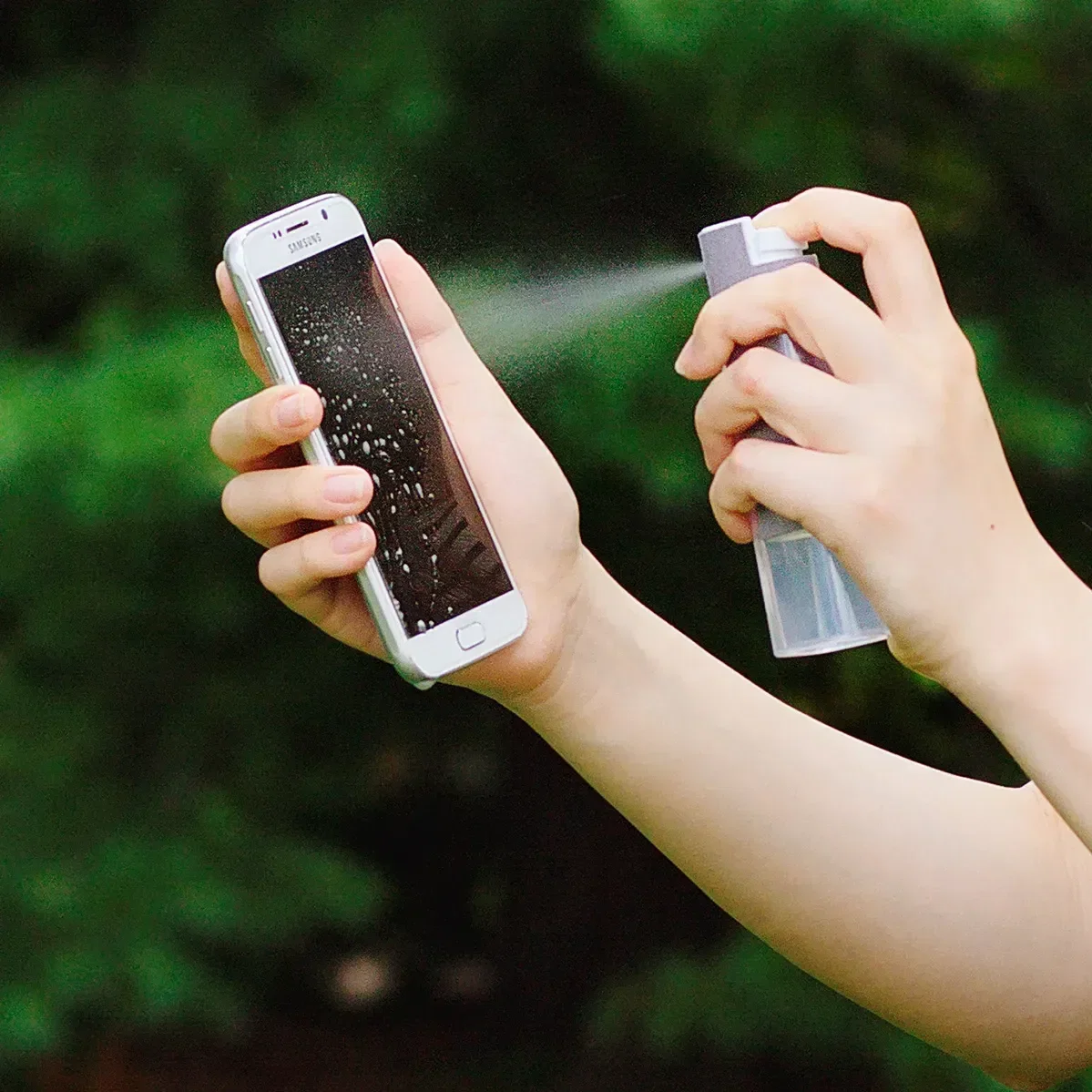 Branded Spray & Swipe antimicrobial cleaner spraying a device screen, logo tech giveaway