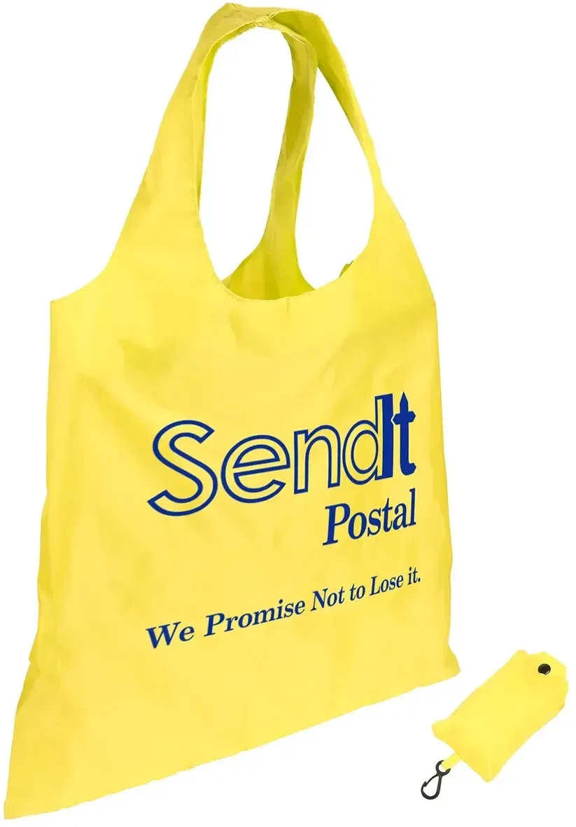 Branded Spring Sling folding tote bag clipped by carabiner to a backpack strap