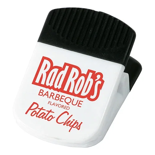 Branded Super Grip clip holding notes on a metal surface, promotional office giveaway