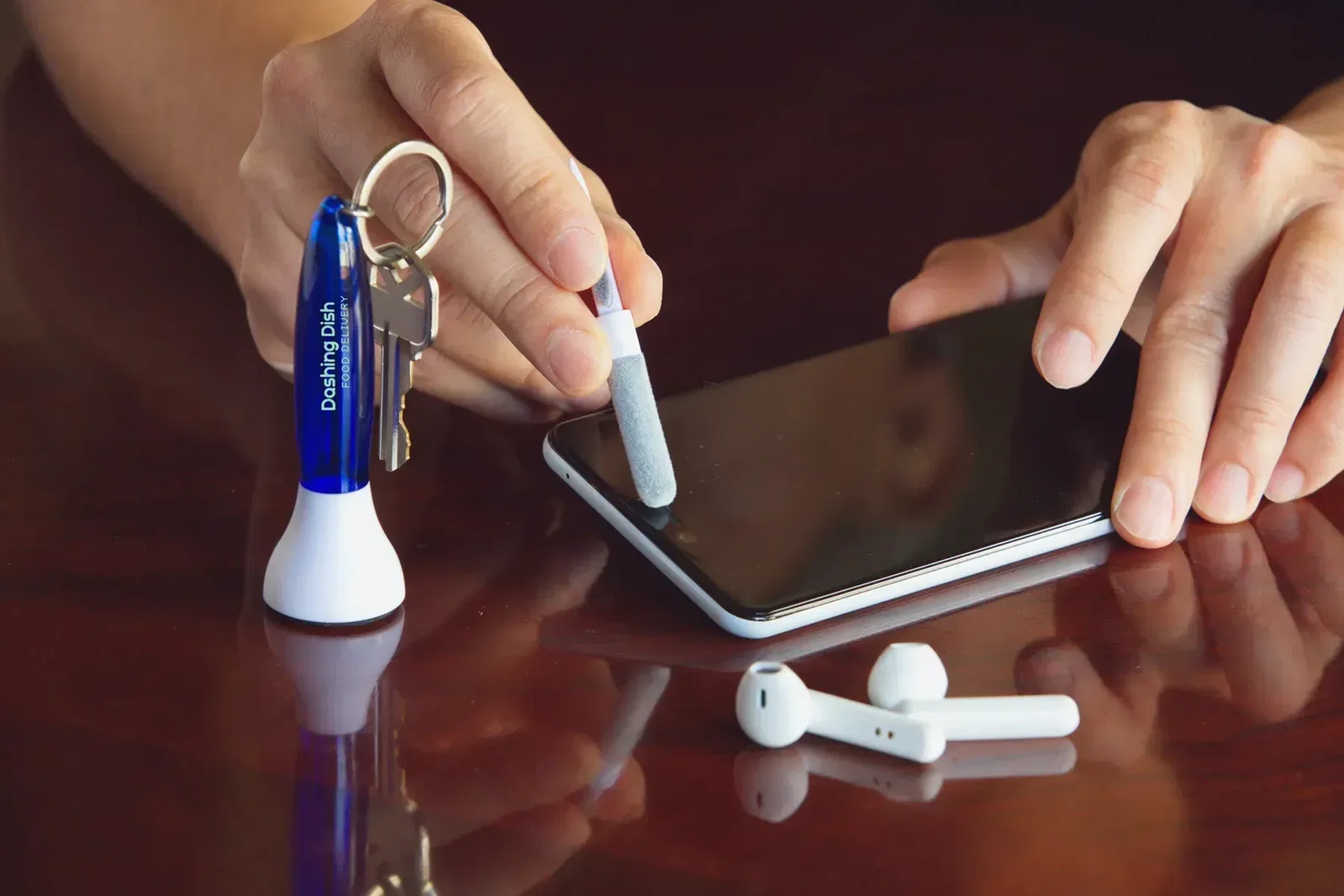 Branded Swab earbud cleaner on a key ring, angled view