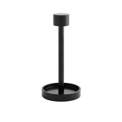 Cocktail napkin holder standing six inches tall on a table