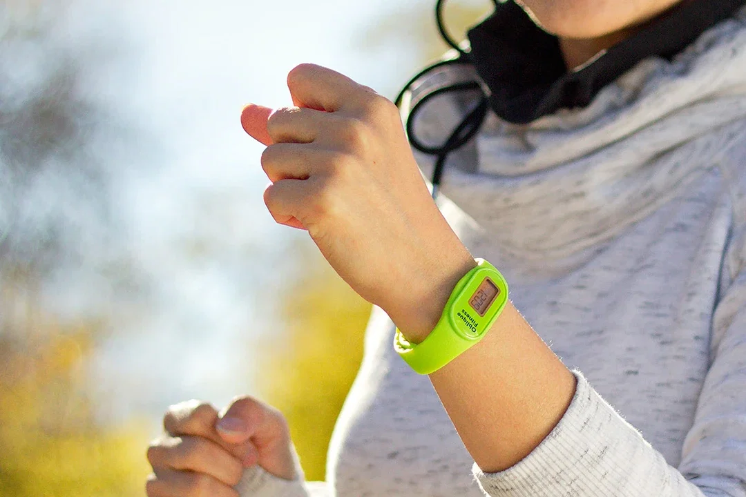 Branded Tap 'N Read Fitness Tracker worn on the wrist, promotional pedometer watch lifestyle shot