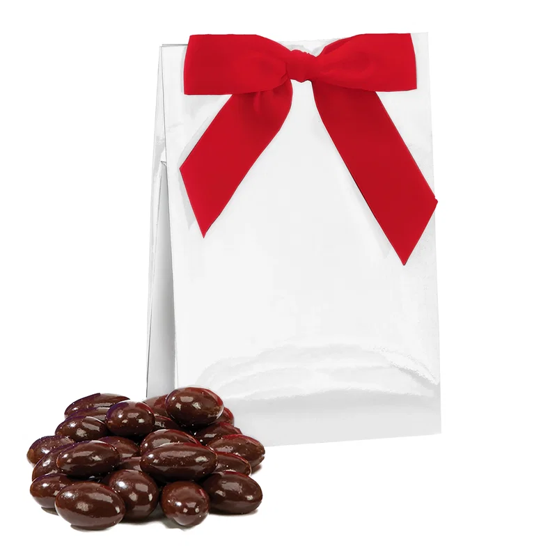 Assorted sweets shown beside their white presentation carton