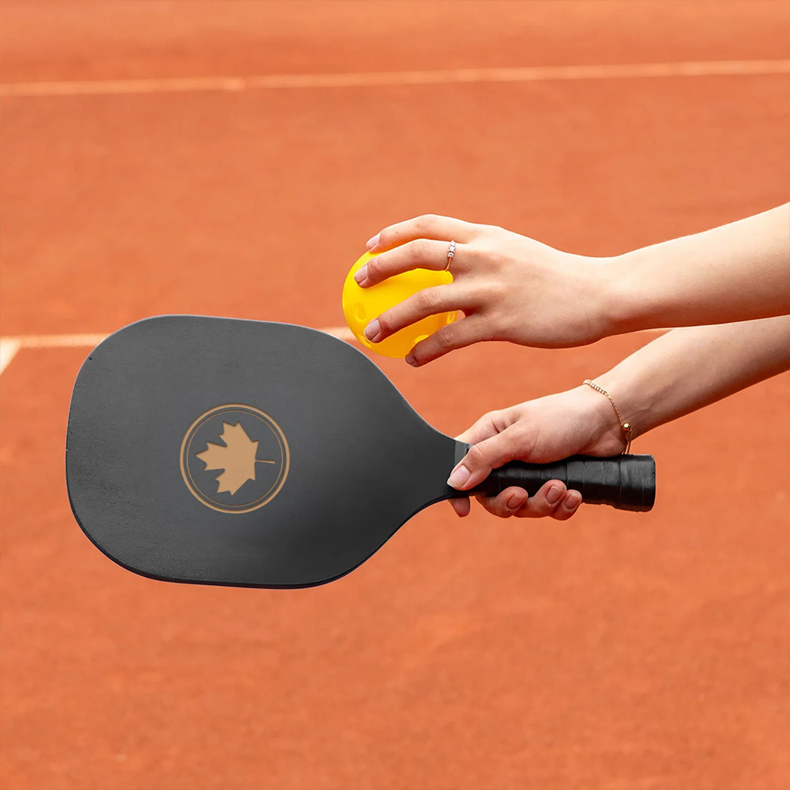 The Pick Up Pickleball Set held in hand