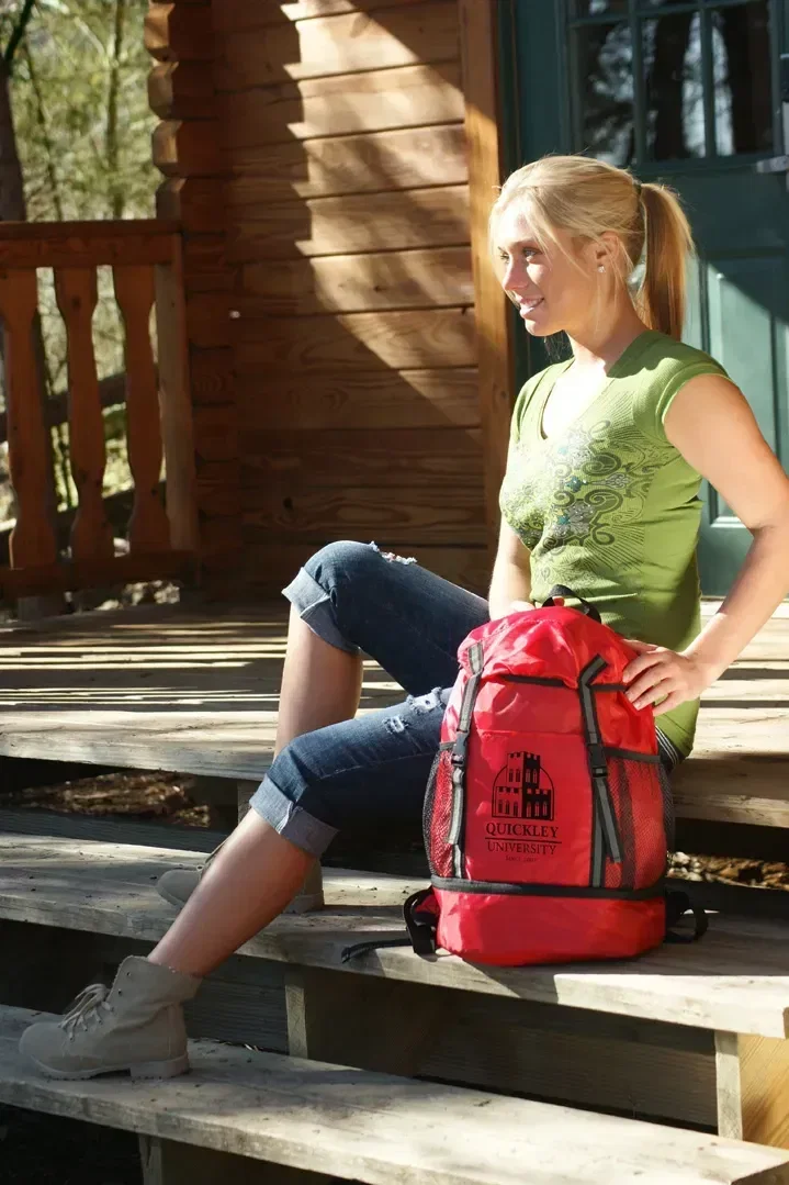Branded Trail Loop drawstring backpack showing zip-bottom shoe compartment open