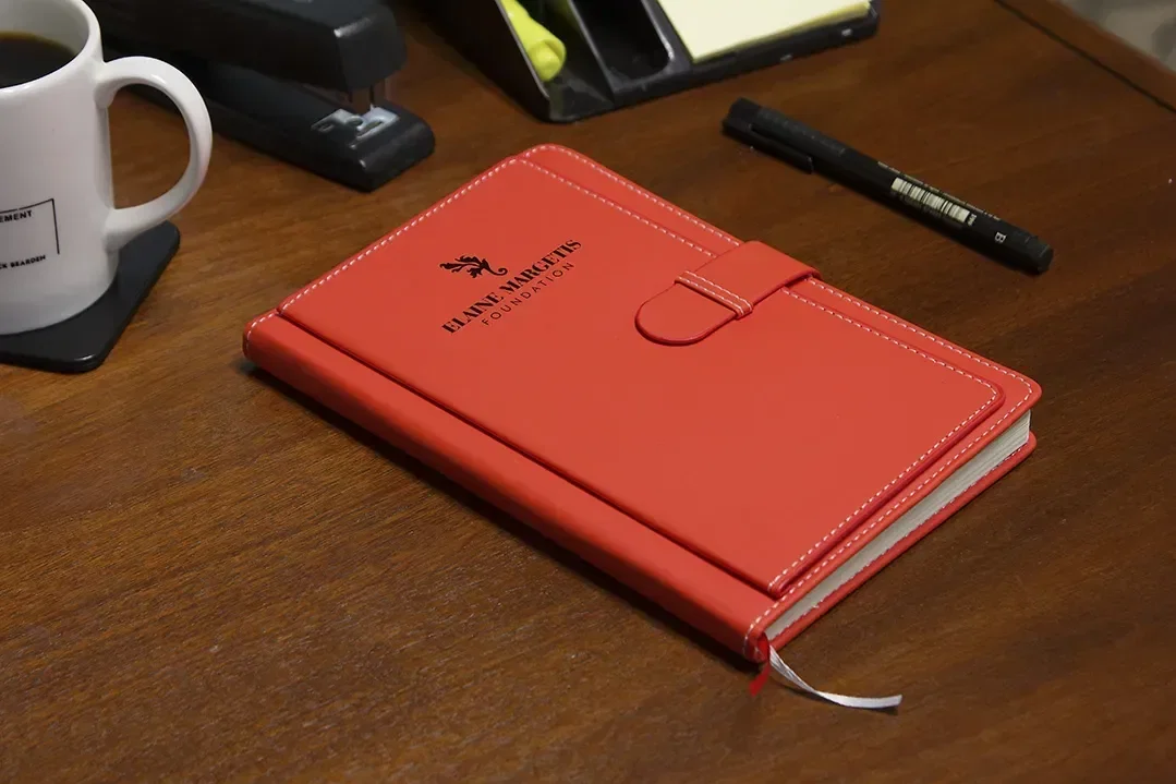 Branded travel journal showing elastic strap closure