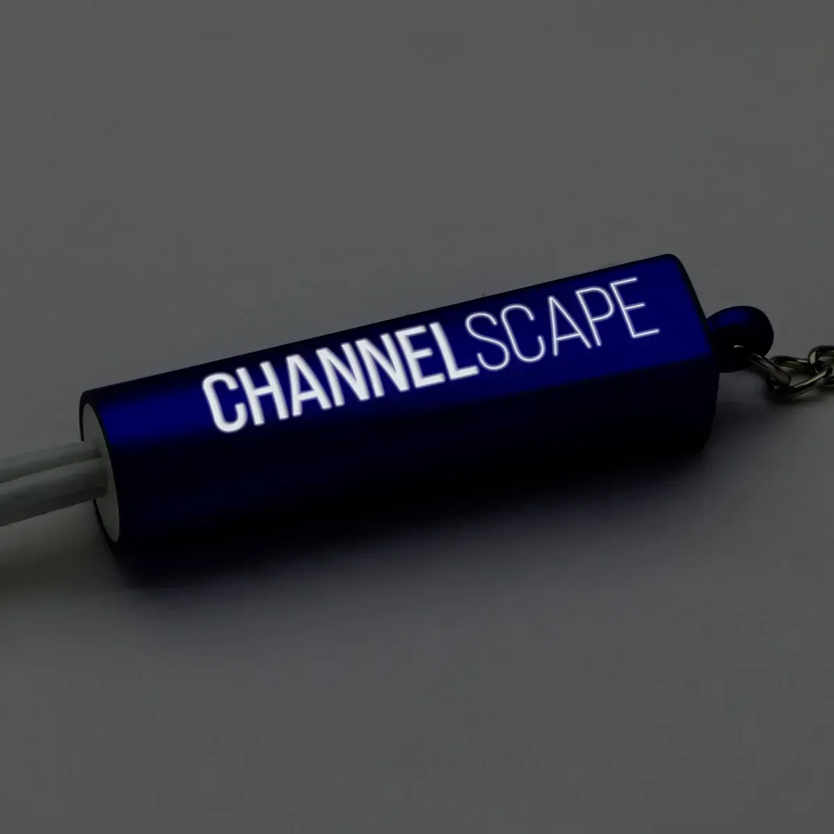 Angled view of the branded Trey light-up keychain promotional charging cable