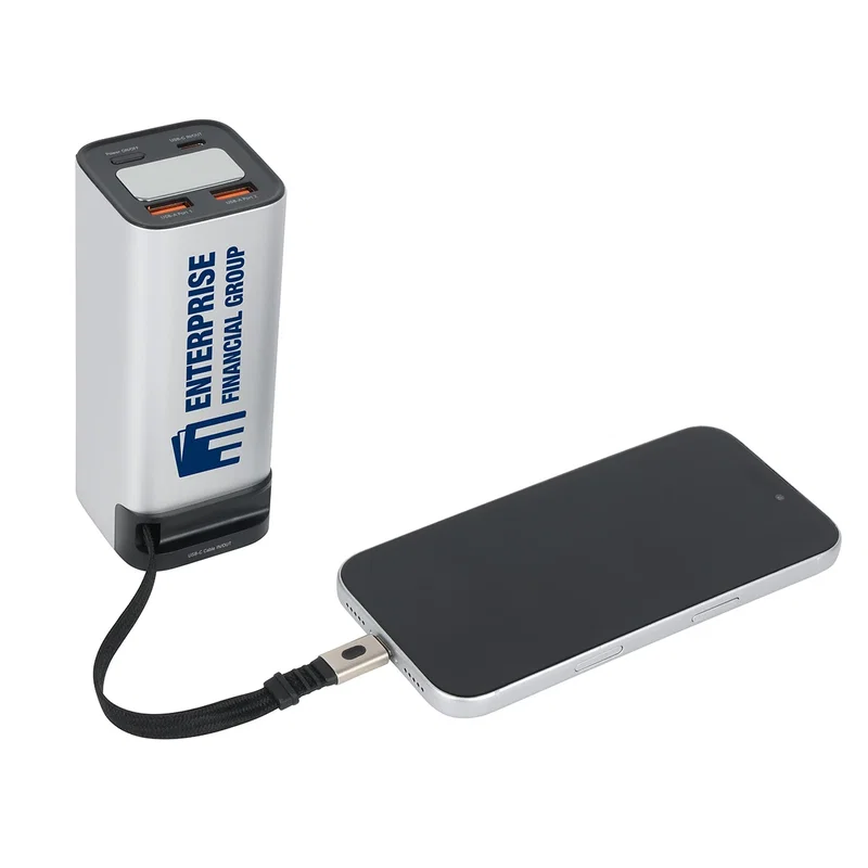 Ultimate power bank in use, charging a laptop via the retractable cable
