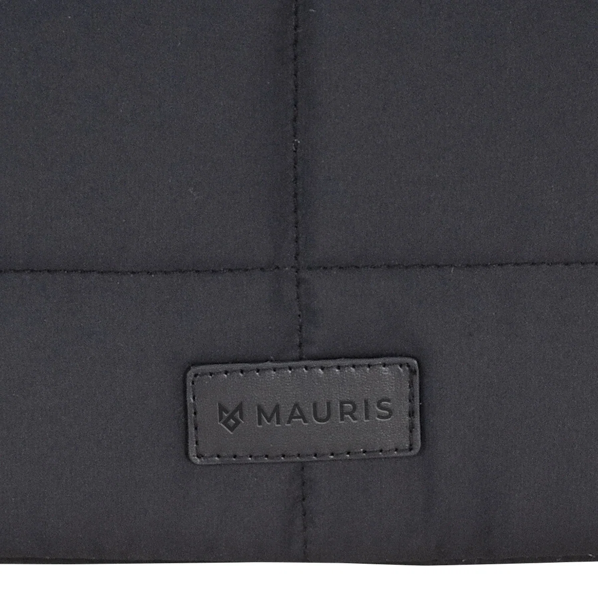 Close-up of the Vallum Quilted Sleeve's diamond-quilted exterior panel and Mauris brand patch