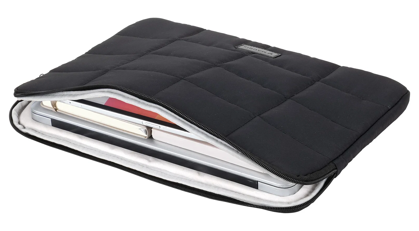 Vallum Quilted Sleeve unzipped at an angle, showing a laptop and tablet tucked inside the padded interior