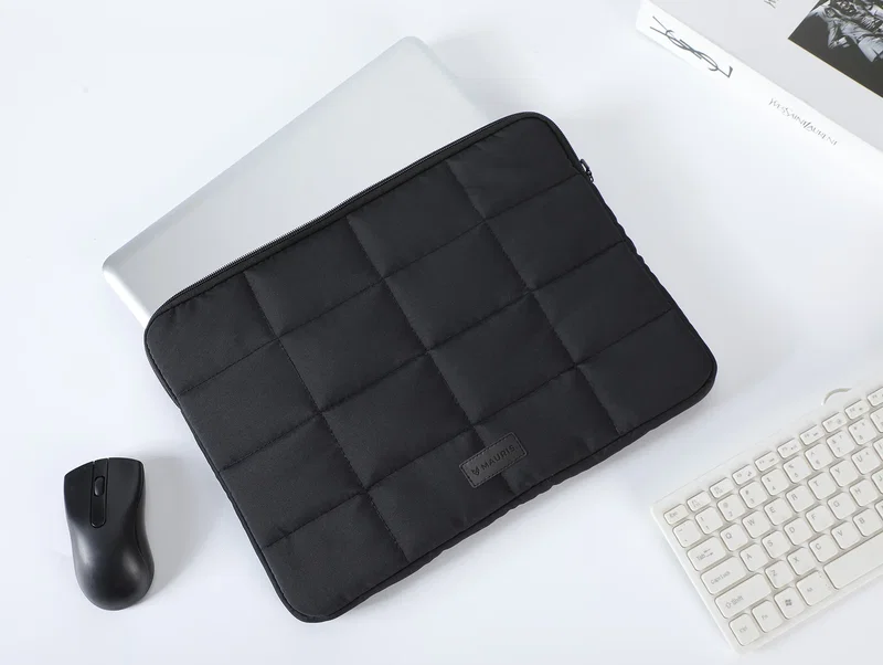 Promotional Vallum sleeve holding a 15-inch laptop, in-use lifestyle shot