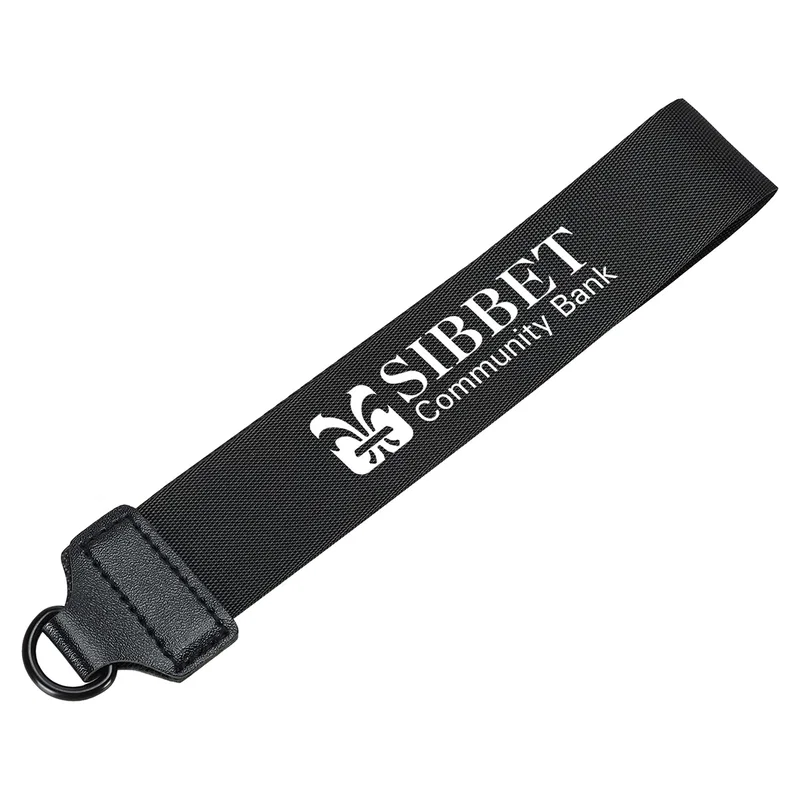 Close-up of the Vogue Wrist Wallet's nylon wrist strap and its custom imprint