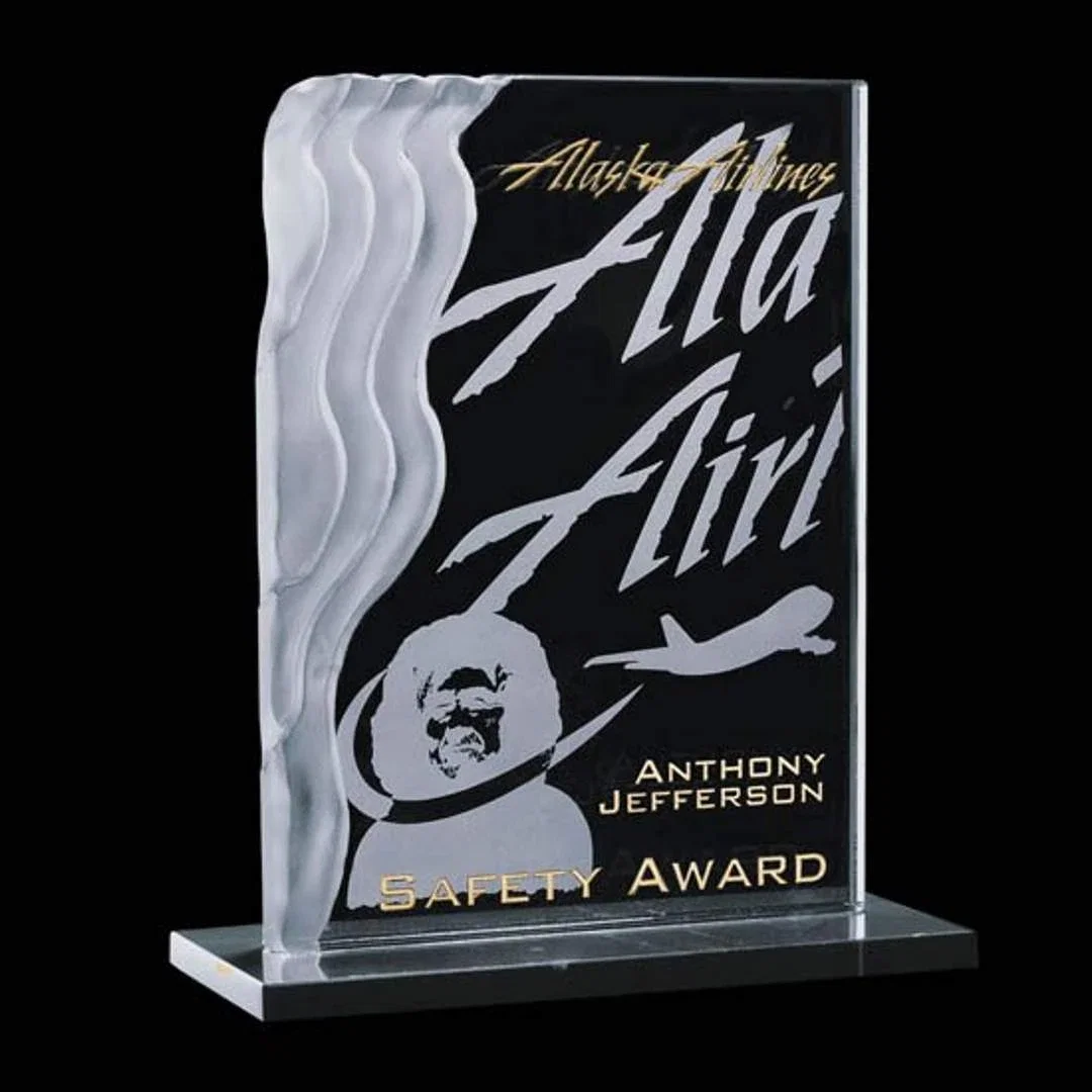 Custom Jade Glass Award With a Sculpted Wave Edge on a Marble Base for corporate award ceremonies