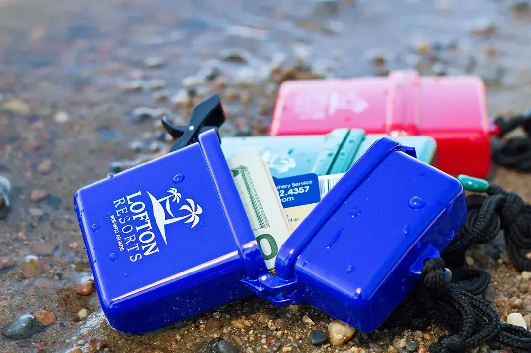 Branded waterproof case holding a phone with lanyard attached, promotional case angled view