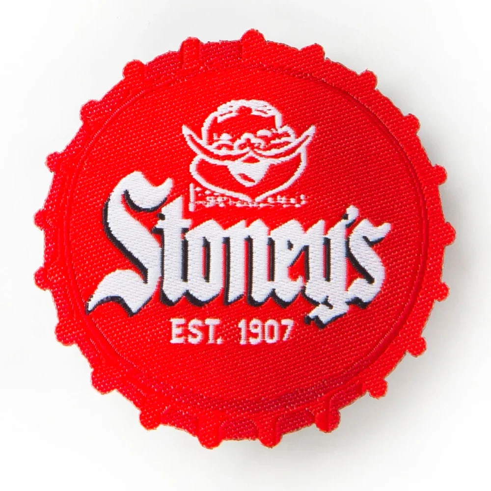 Round badge photographed from a three-quarter angle
