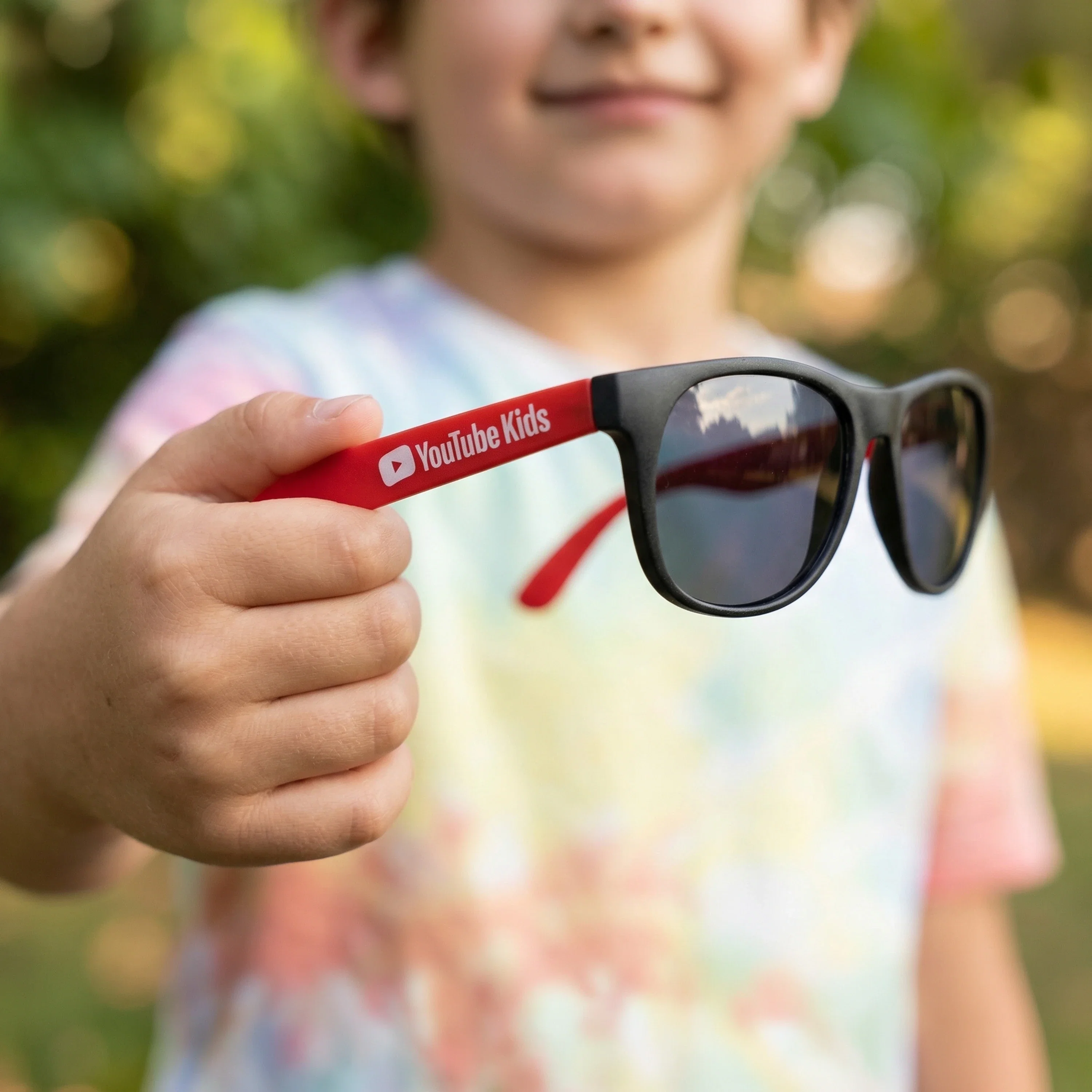 Imprinted Youth Rubberized Sunglasses held in hand